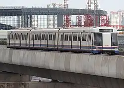EMU-IBL approaching Tao Poon station with the unfinished Krung Thep Aphiwat Central Terminal in the background in 2018.