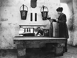 Fire buckets at a British munitions plant during World War&nbsp;I, marked with the royal cypher of George V