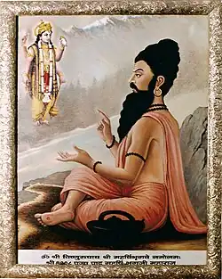 Painting of a seated holy man, looking at a deity