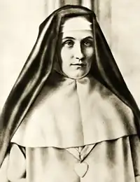 The religious habit of the Sisters of the Good Shepherd (and also of the Sisters from the Order of Our Lady of Charity) is white, with a white scapular, a black veil and a large silver heart on the breast.
