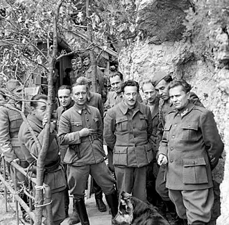 Photograph of a group of uniformed men posing for a photo