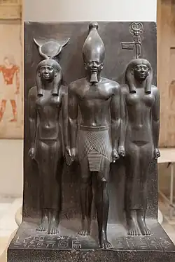 Goddess representation in Egyptian monuments: in this triad the Egyptian goddess Hathor (left) and the nome goddess Bat (right) lead Pharaoh Menkaura (middle). Egypt, Fourth dynasty, about 2400 BCE. Graywacke. Cairo Museum.