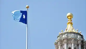Minnesota flag flying on the eastern flagpole