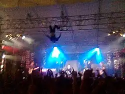 Kody Nielson hangs upside down over the stage during a performance at Auckland University of Technology
