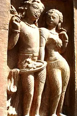 Male and female statues wearing drapes at Nachna Hindu temples.