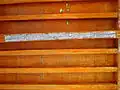 Wooden beam ceiling with an inscription indicating the date of its construction.