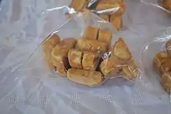 Typical muéganos, prepared and wrapped, being sold in a market in Huamantla, Tlaxcala.