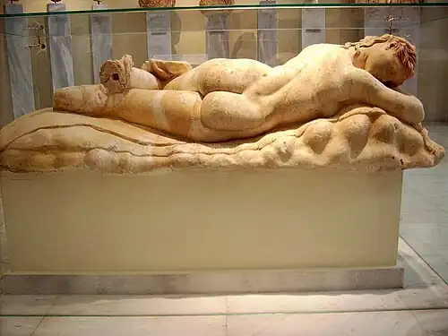 Statue of a sleeping Maenad, lying on a panther skin spread on a rocky surface; the type is known as the reclining Hermaphrodite; Pentelic marble; found at the south of the Athenian Acropolis; Hadrianic time (117–138 AD), follows a classical trend in Attic art; National Archaeological Museum, Athens.
