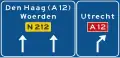 K11: Lane instructions on a non-motorway highway. Panel showing intermediary destinations, road numbers and directions to a motorway