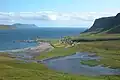 The sandy beach of Nes at Hvalba, view to Stóra Dímun (island).
