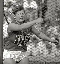 Nina Ponomaryova from about the highs up, posing in a way that appears to be her just finishing a discus throw. Image is in black and white.