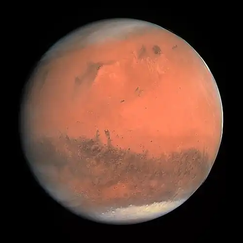 Image 16 Mars Photograph credit: European Space Agency Mars is the fourth planet from the Sun and is known as the "Red Planet" due to its reddish appearance as seen from Earth. The planet is named after Mars, the Roman god of war. A terrestrial planet, Mars has a thin atmosphere and surface features reminiscent both of the impact craters of the Moon and the volcanoes, valleys, deserts and polar ice caps of the Earth. The planet has the highest mountain in the Solar System, Olympus Mons, as well as the largest canyon, Valles Marineris. Mars's rotation period and seasonal cycles are also similar to those of the Earth. Of all the planets in the Solar System other than Earth, Mars is the most likely to harbour liquid water and perhaps life. There are ongoing investigations assessing Mars's past potential for habitability, as well as the possibility of extant life. Future astrobiology missions are planned, including NASA's Mars 2020 rover and the European Space Agency (ESA)'s Rosalind Franklin rover. In November&nbsp;2016, NASA reported finding a large amount of underground ice in the Utopia Planitia region of the planet. The volume of water detected has been estimated to be equivalent to the volume of water in Lake Superior. Mars has two moons, Phobos and Deimos, which are small and irregularly shaped. This picture is a true-colour image of Mars, taken from a distance of about 240,000 kilometres (150,000&nbsp;mi) by the OSIRIS instrument on ESA's Rosetta spacecraft, during its February&nbsp;2007 flyby of the planet. The image was generated using OSIRIS's orange (red), green and blue filters. More selected pictures