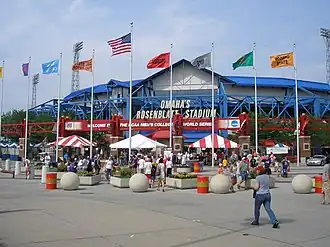 The red, white, and blue façade of a steel and concrete ballpark