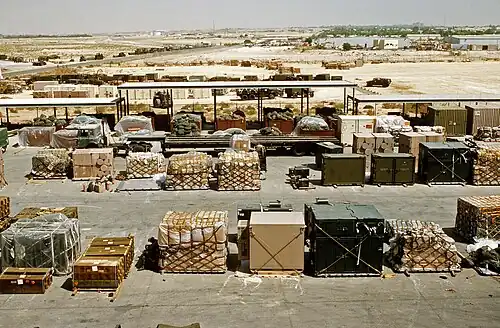 Pallets and containers of equipment sit in a logistics support area during Operation Desert Shield, 1991