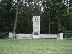 Granite pillar with a carved inlay of a male figure