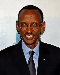 Close up photo of Paul Kagame smiling at the premiere of the film Earth Made of Glass