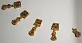 Five of the necklace pendants (one slightly damaged) (GNM)