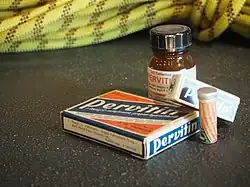Several different methamphetamine tablet containers photographed on a table