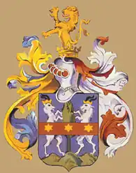 A purple shield with two standing goats and a crimson band with three six-pointed stars in the middle surrounded by gold, white and purple decorative elements and topped by a gold lion rampant