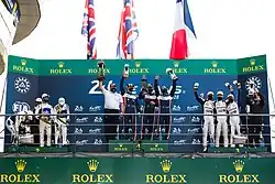 A podium ceremony with drivers and delegates