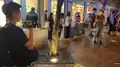 Police officers used cameras to film citizens waiting at the bus stop.