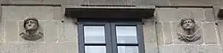 Two more heads on the façade