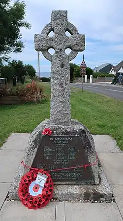 Historic interest: as an eloquent witness to the tragic impact of two World Wars on a small community.community, and the sacrifice it made in the conflicts of the C20. Architectural interest: for its design, a well-executed Celtic cross hewn from local granite.