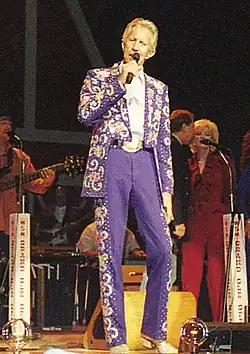 Porter Wagoner wearing elaborate Nudie suit