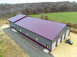 Image 11Post frame Barndominium with standing seam metal roof. Large garage on the front side and living space on the back end. (from List of house types)