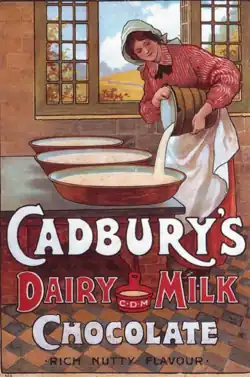 A dairymaid pours milk into containers in a kitchen. Large text says "Cadbury's Dairy Milk Chocolate: Rich Nutty Flavour"