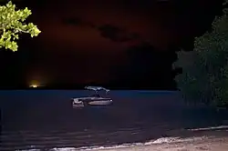 Boat at Puerto Ferro at night, seen from Peninsula Road in Vieques