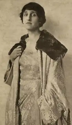 Regina Vicarino, from a 1921 publication, wearing a dress with heavy embroidery embellishment