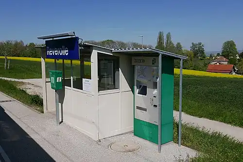 White station shelter next to a ticket machine