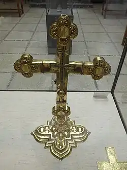 An image showing the reverse side of a silver altar cross. The removal of panels on the reverse of the cross reveals a smaller cross inside.