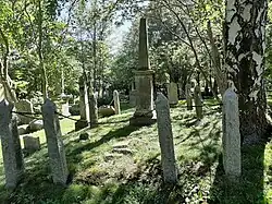 The Rogerson Vault at the General Protestant Cemetery in St. John's, Newfoundland and Labrador. There is a central obelisk surrounded by stanchions connected by an iron chain.