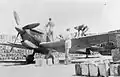 Refuelling and rearming a Spitfire Mark VC(T), in a revetment constructed from empty fuel tins filled with sand at RAF Ta Kali, Malta in 1942