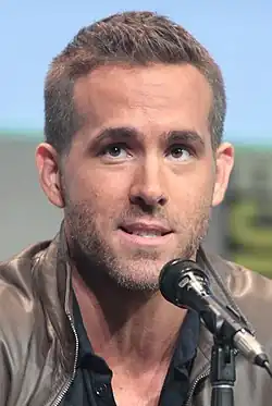 Reynolds speaking into a microphone