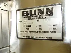 Close-up of the Bunn label on a coffee grinder.