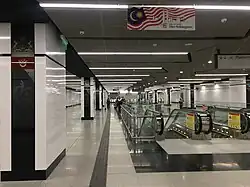 Flags and emblems of Malaysian states on the pillars at the Lower Concourse Level of the station.