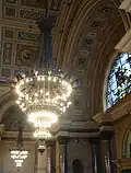 One of the ten chandeliers, brass and bronze, decorated with prows of ships, heads of Neptune and Liver birds, by Cockerell