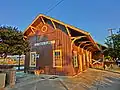 A wooden railroad station building