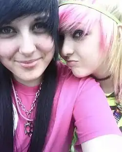 Image 52Two teen girls in scene style, with dyed hair, bright graphic tops, and edgy jewelry typical of MySpace-era subcultures, 2010. (from 2010s in fashion)