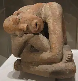 Terracotta seated figure; 13th century; earthenware; 29.9&nbsp;cm (113⁄4&nbsp;in.) high; Metropolitan Museum of Art (New York City, USA) The raised marks and indentations on the back of this hunched Djenné figure may represent disease or, more likely, scarification patterns. The facial expression and pose could depict an individual in mourning or pain.