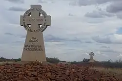 Photograph of two memorial crosses on stone mounds