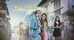 An image of Tom Rodriguez, Lovi Poe and Max Collins. Rodriguez and Collins are both holding an umbrella. The series title is displayed on the left side of the image.