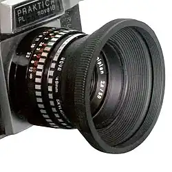 Praktica camera – lens with a conical collapsible rubber lens hood (50&nbsp;mm f/2.8).