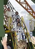 The TMA-05M crew wave to spectators before launch on 15 July 2012.