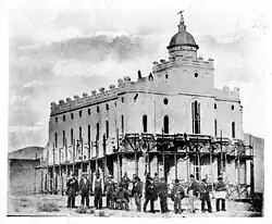 St. George Utah Temple Squatty, Short Dome. A team of workers pose in front of the temple, currently under process for a whitewash.