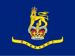 A blue flag with a crown and lion in the center, placed above a banner.