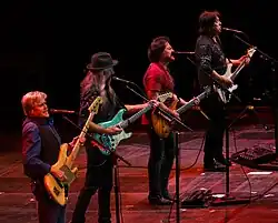 The Doobie Brothers performing in 2017. From left: touring member John Cowan, Patrick Simmons, Tom Johnston, and John McFee.
